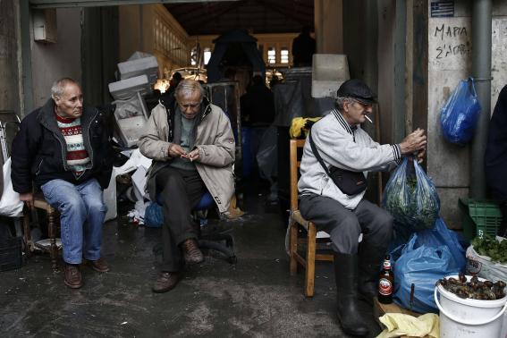 Street vendors are seen at the entrance of Athens' main fish market